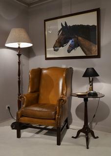 An Early 20th Century English Wing back Leather Chair having a very nice patina.