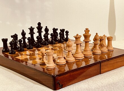 An English 19th Century Mahogany Chess Board / Box and an English 19th Century Staunton Chess Set.