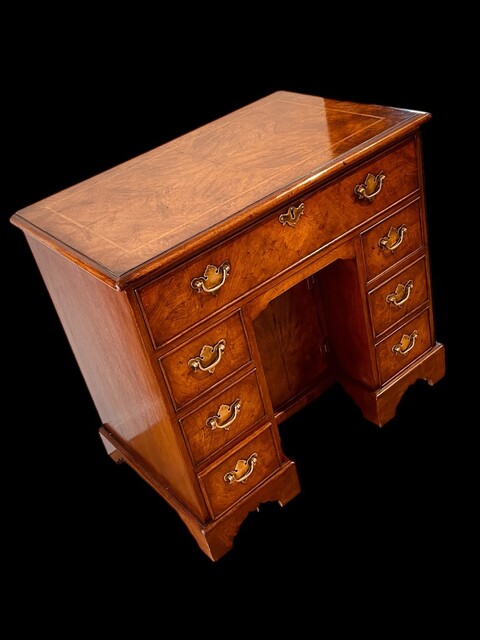 An English 19th Century Burr Walnut Kneehole Desk.