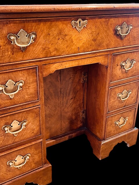 An English 19th Century Burr Walnut Kneehole Desk.